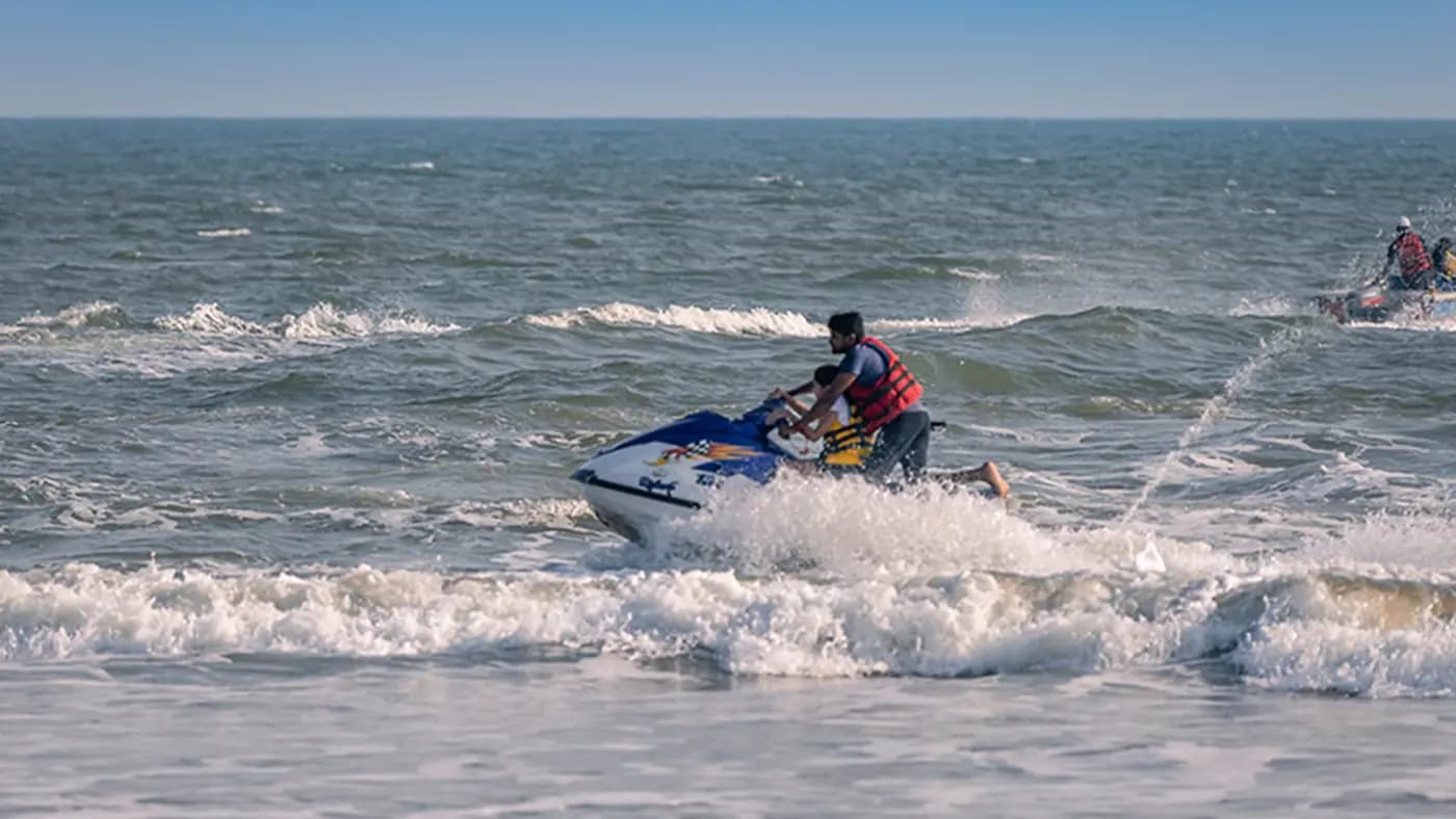 Active jet ski ride on sea waves in daylight at Eco Retreat Konark