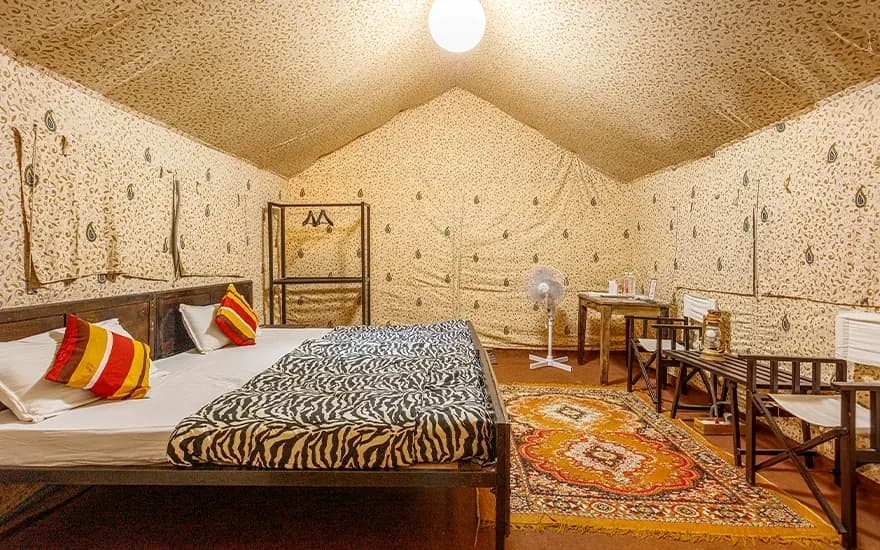 Wide twin-bedroom interior with sitting area at Rann Utsav — reference