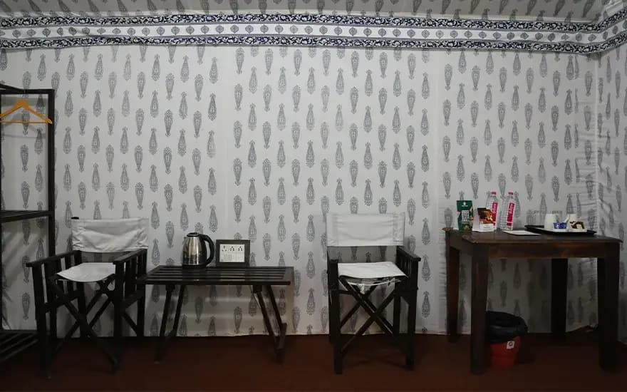 Twin chairs, tea table and console in cottage at Rann Utsav — reference