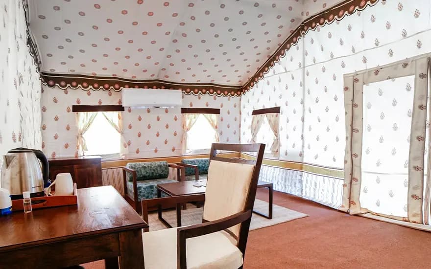 Seating area and tea-making console beside tent entrance at Rann Utsav — reference