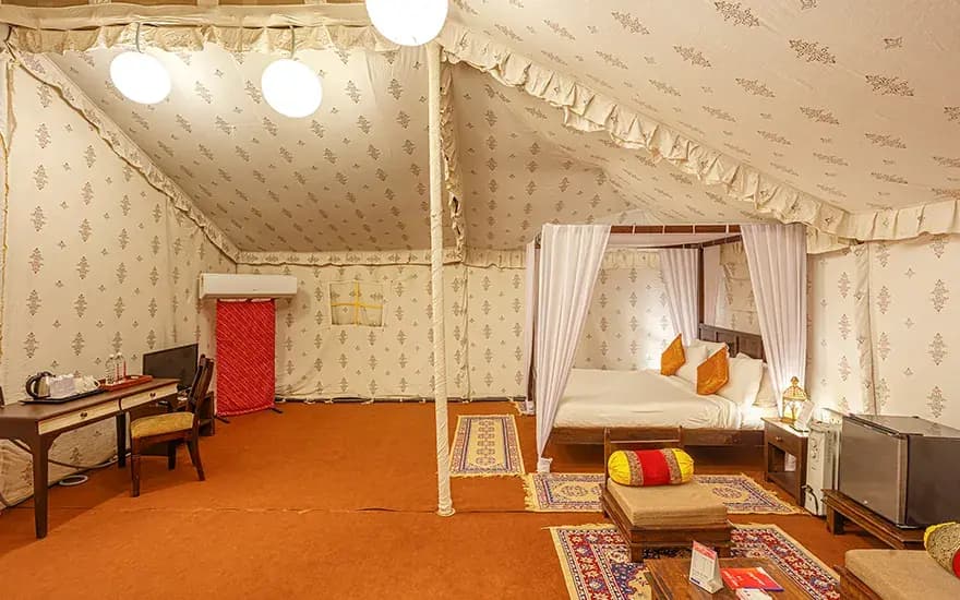 Side view of canopy bedroom and sitting area at Rann Utsav — reference