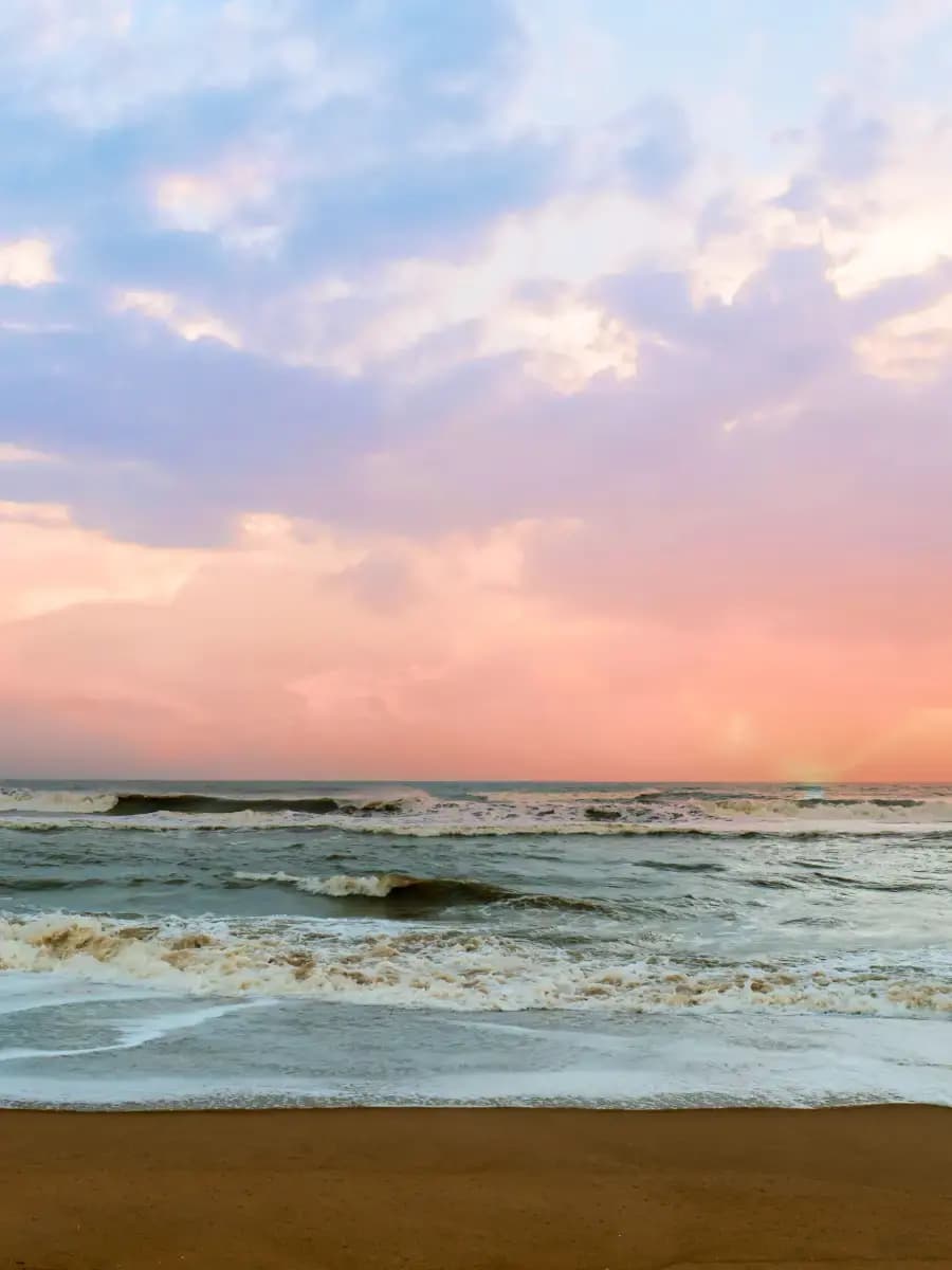 Sonapur Beach surf and shoreline beneath pastel evening clouds